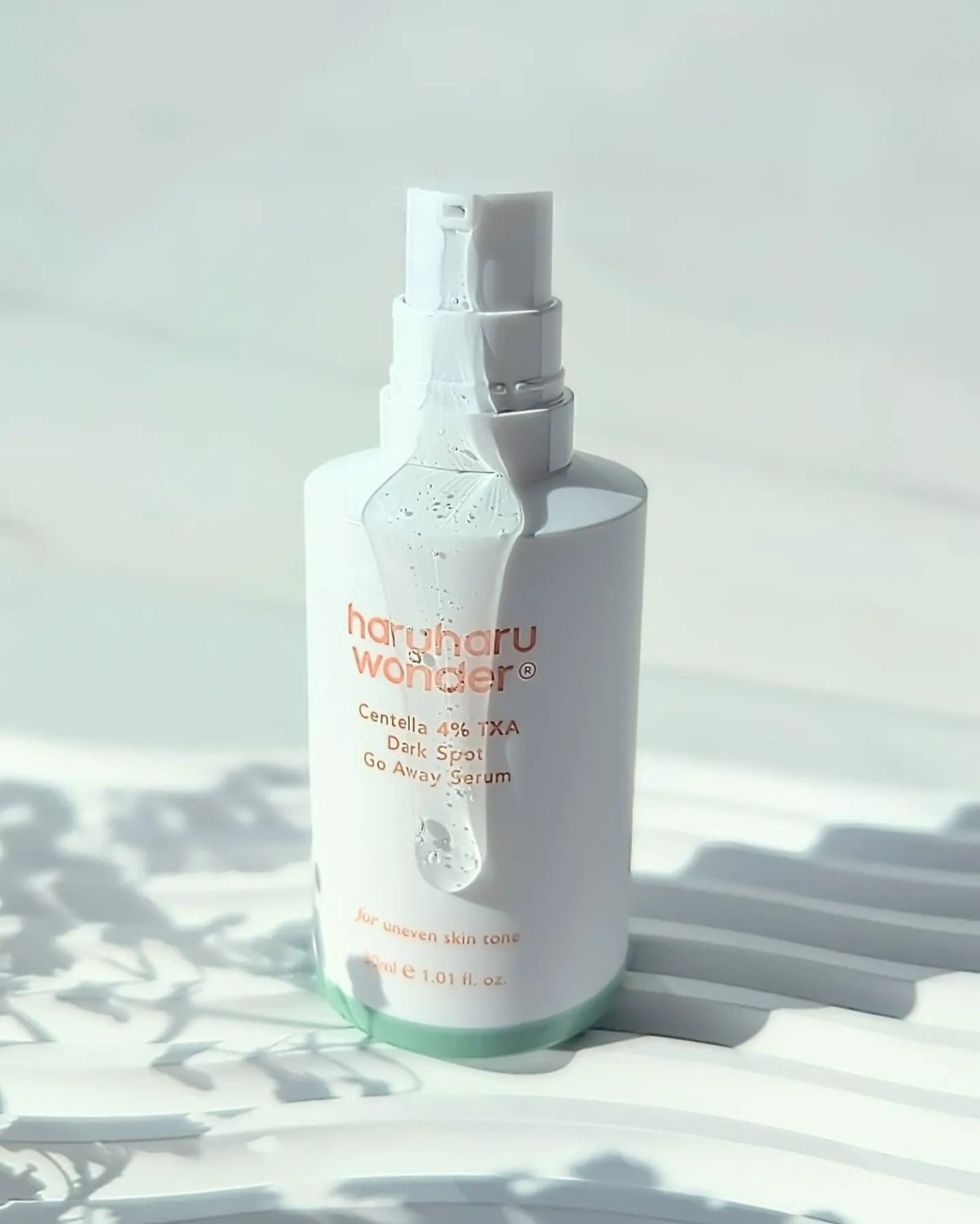 Haruharu Wonder Centella 4% TXA Dark Spot Go Away Serum pump bottle with gel texture in sunlight — EmartGCC Kuwait