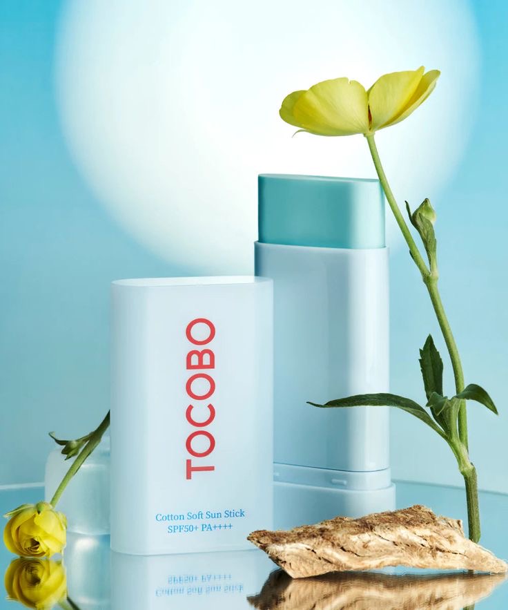 Tocobo Cotton Soft Sun Stick open with yellow flower on blue background — EmartGCC Kuwait