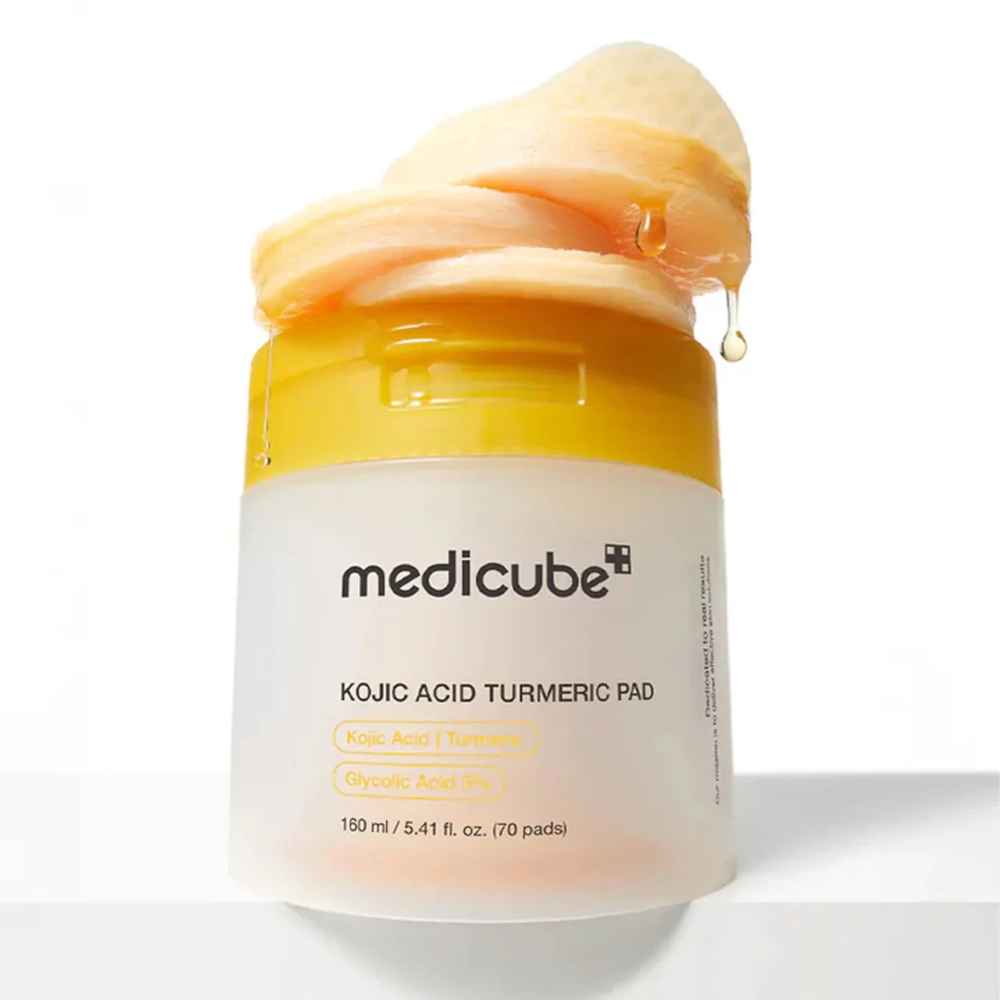 Medicube Kojic Acid Turmeric Pad dual-textured design — embossed exfoliating side and smooth soothing side